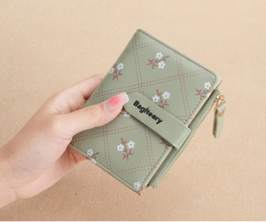 Close-up of a mint green short PU leather wallet featuring white floral and diamond patterns