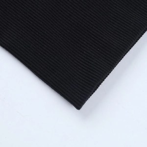 Detailed close-up of high-density black knit ribbed texture on sleeve cuffs and hemline