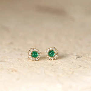 Macro detail of vintage-style S925 silver stud earrings with round emerald and diamonds