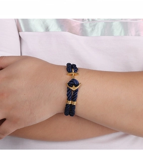 Detail of navy nylon rope bracelet for men with golden anchor hook clasp on wrist