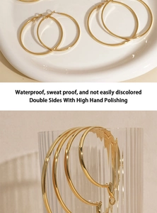 Polished gold large hoop earrings with waterproof and sweatproof durability details