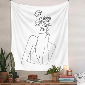 Modern white tapestry with minimalist floral line art portrait in a cozy home decor setting