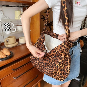 Detail of leopard print canvas tote bag with magnetic closure and wide shoulder strap