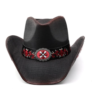 Detailed view of black cowboy hat with red embroidery and silver floral ornament