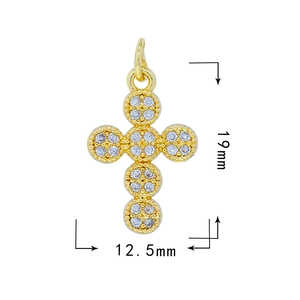 Macro detail of 18k gold plated cross pendant with zircon stones and 19x12.5mm dimensions