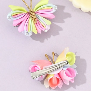 Detail view of handmade colorful fabric butterfly clips with rhinestones and metal clip