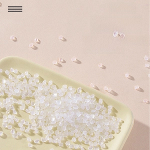Macro view of high-transparency PET plastic raw material pellets for cosmetic bottles