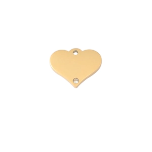 Detail of gold heart pendant with mirror finish and single small sparkling rhinestone