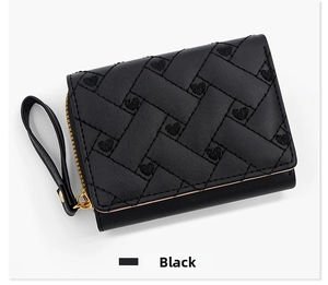 Detail of black PU leather wallet with heart embroidery and golden metal zipper