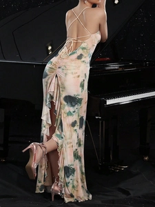 Tie-dye backless maxi dress with cross straps shown next to a piano