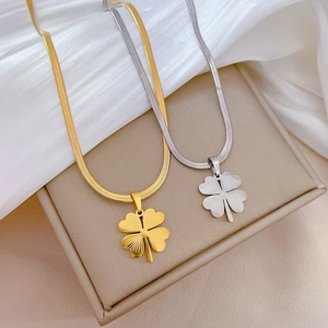 Flat snake chain necklaces with four-leaf clover pendants in gold and silver finishes