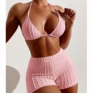 Pink ribbed two-piece bikini set with halter top and high-waisted shorts for women