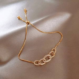 Detail of adjustable gold chain bracelet with zircon pavé interlocking oval links