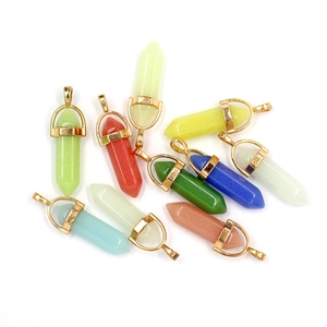 Close-up of multicolored hexagonal crystal pillar pendants with gold-plated metal clasps