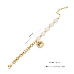 Detail view of golden stainless steel bracelet with white pearls and tree of life charm