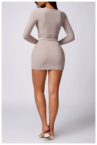 Detail view of the elegant ruched design on the back of this slim fit taupe mini dress