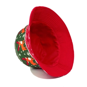 Christmas bucket hat with reindeer and snowflake print on green twill cotton fabric