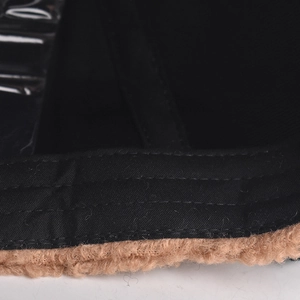 Detail of sturdy triple stitching on black canvas and brown faux shearling cap fabric