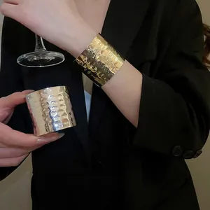 Irregular hammered metal cuff bracelet in gold and silver finish for a luxury look