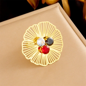 Gold-plated hollow flower ring with faceted white red and black gemstones inlay