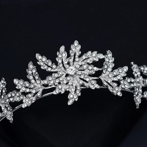 Sparkling silver crystal bridal tiara with intricate rhinestone leaf patterns on black backdrop