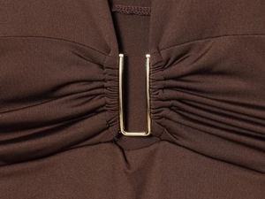 Detailed view of dark brown ruched fabric featuring a premium gold U-shaped metal hardware