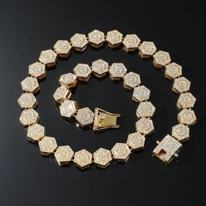 Macro detail of gold hexagonal chain links with full pave diamonds and snap clasp closure