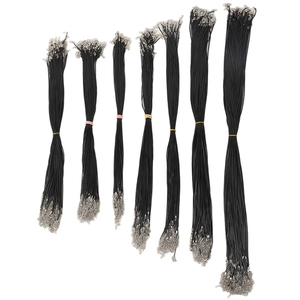 Multiple bundles of black waxed necklace cords with silver clasps in various lengths