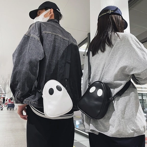 Detail view of stylish ghost-shaped PU leather crossbody bags in black and white colors
