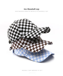 Close-up of three checkered baseball caps stacked vertically in black, brown and blue colors