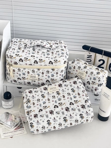 Detailed set of three quilted cotton cosmetic bags with cute cartoon dog print