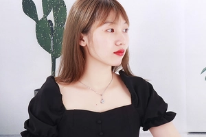 Silver stainless steel necklace with round coin pendant on a female model