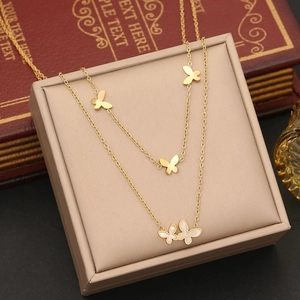 Elegant gold double layer necklace with shell butterfly pendants on vintage background