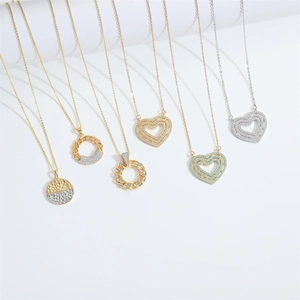 Multi-layered gold and silver heart necklaces with zircon pendants on a white background