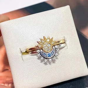 Elegant sun and moon stacking ring set with gold sun and silver moon with blue crystals