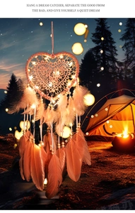 Macro shot of heart-shaped dream catcher with glowing LED lights and soft pink feathers