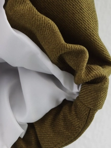 Detail shot of premium brown corduroy fabric with white silky lining on a fashion jacket