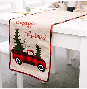 Christmas table runner with red plaid truck and green tree pattern on beige linen fabric