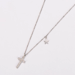 Detailed macro of silver cross pendant with crystals and star charm on O-chain necklace