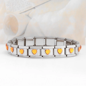 Detail of silver stainless steel Italian charm bracelet with orange heart stones