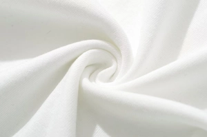 Macro view of white fabric texture showing soft ruffled layers and elastic material