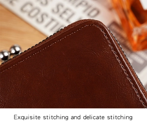Detailed close-up of brown leather stitching and fine texture on a vintage coin purse