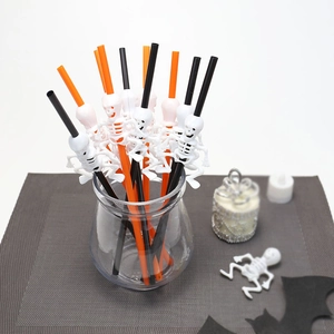 Detail of Halloween party straws with white skeleton decorations in a glass jar