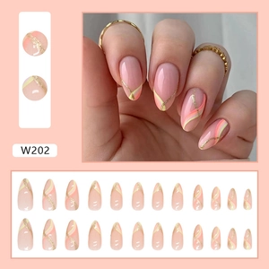 Detail of almond press-on nails with pink yellow gradient and gold glitter stripes