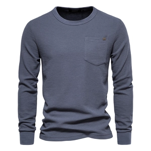 Detail of waffle knit fabric and chest pocket on a long-sleeved gray-blue men's t-shirt