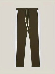 Close-up of olive green track pants featuring contrast side stripes and drawstring waist