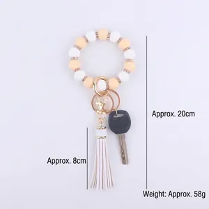 Silicone bead keychain bracelet with yellow beads, rhinestone spacers and white leather tassel