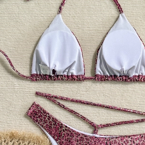 Detailed view of pink leopard print bikini with metallic sheen and soft neck ties