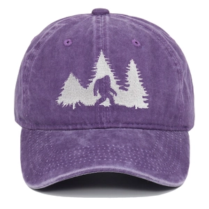 Macro detail of white Bigfoot silhouette embroidery on washed purple cotton baseball cap