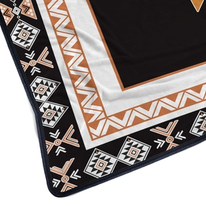 Macro detail of flannel blanket showing ethnic tribal geometric patterns and soft texture